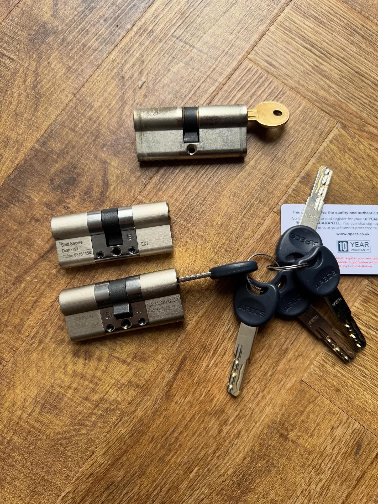 Basic euro lock laid next to anti snap lock on a wooden surface