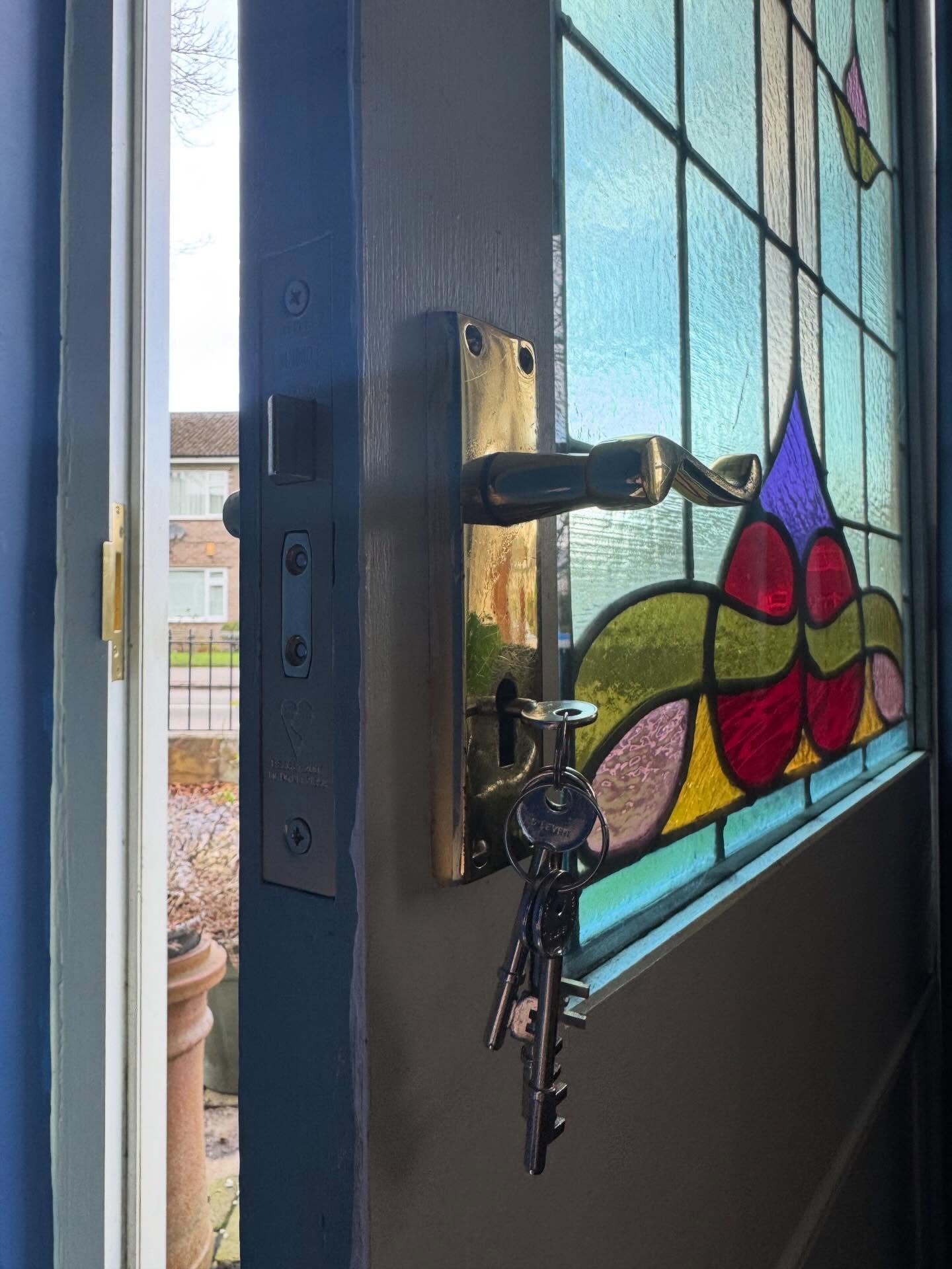 BS3621 sash lock fitted in Totley to a door with handle and keys featuring a stained glass window