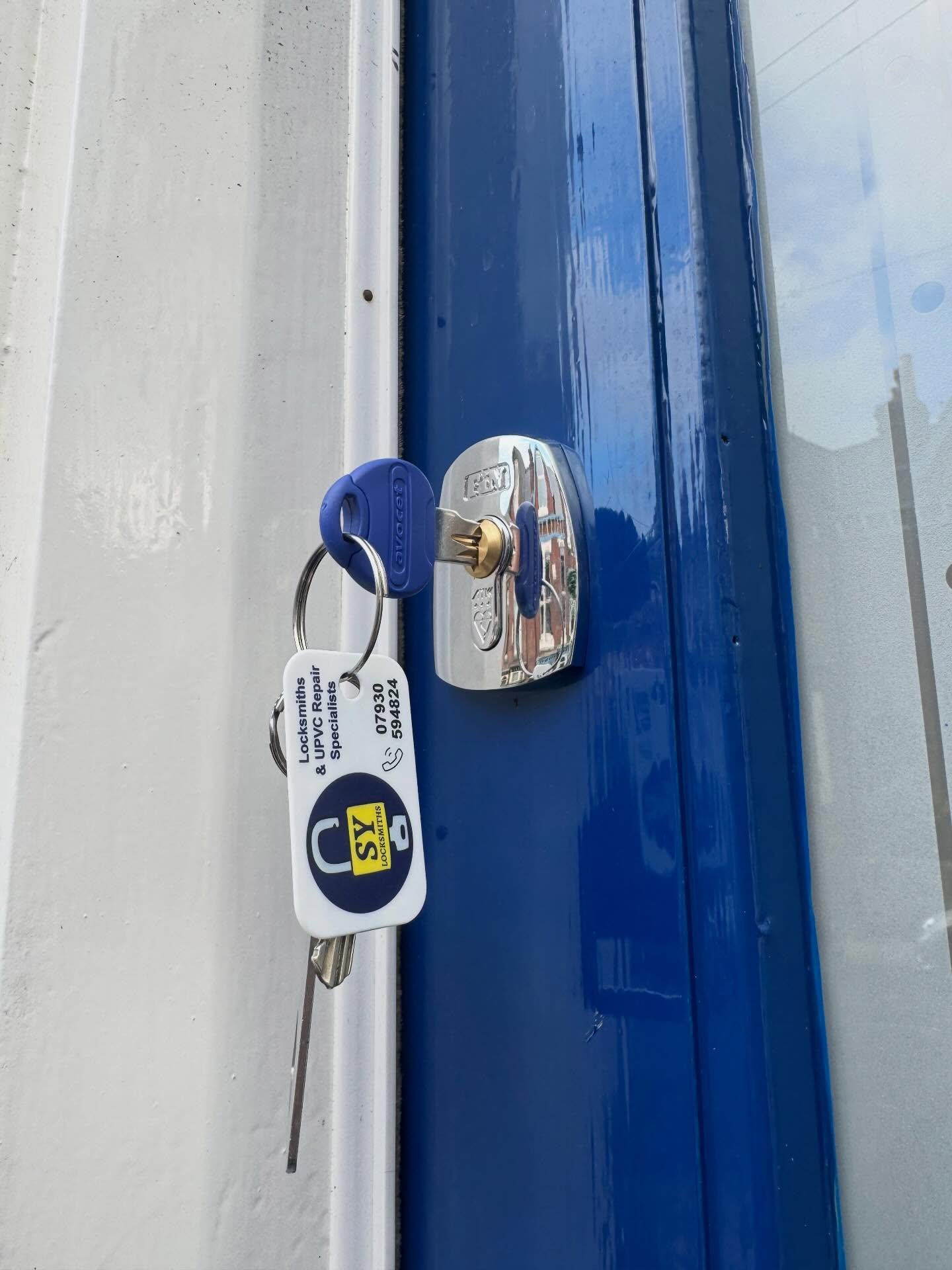 Blue door with a replacement lock and key after gaining entry to a residential property in Hillsborough