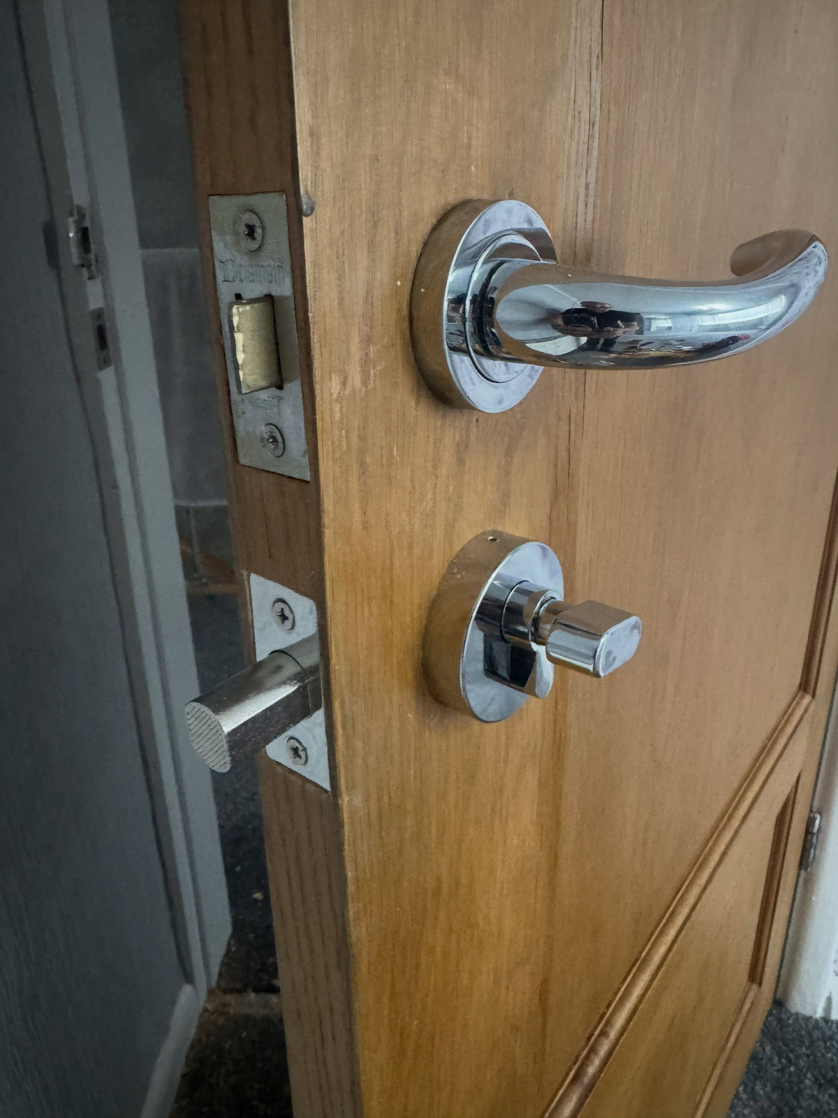 Chrome deadbolt fitted to brown wooden door in Hillsborough