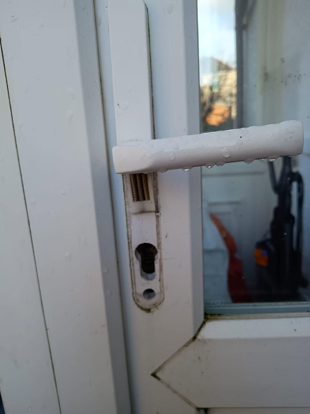 Lock and handle snapped on white upvc door after a lock snapping burglary in Sheffield