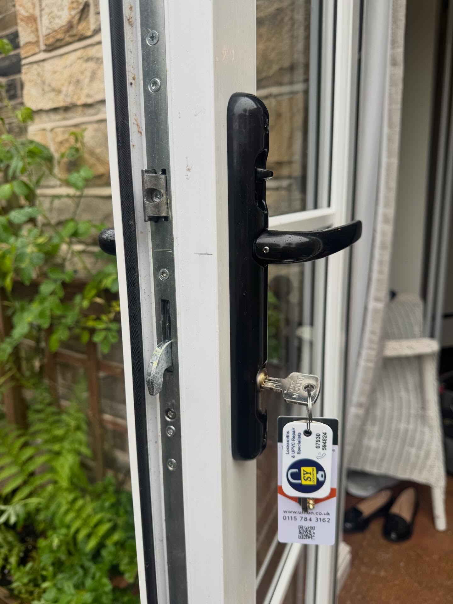 Lockmaster multi point lock fitted to white composite door with black handles in Nether Edge  