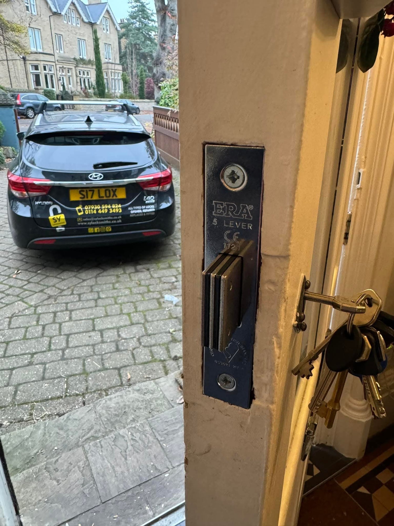 Emergency call out to property in Sheffield picturing SY Locksmiths vehicle and lock