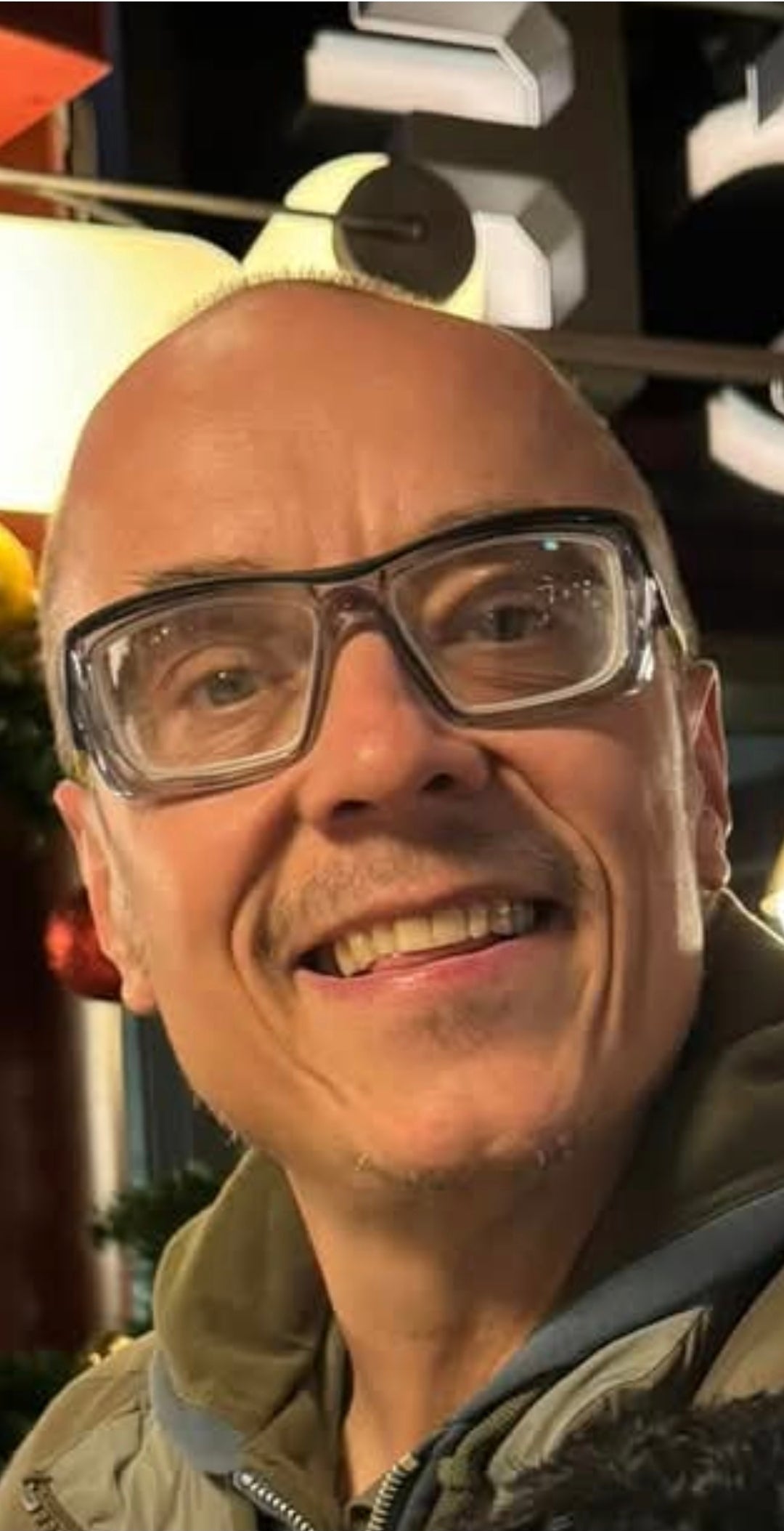 Steve Yeoman owner of SY Locksmiths wearing glasses and a jacket with a blurred background