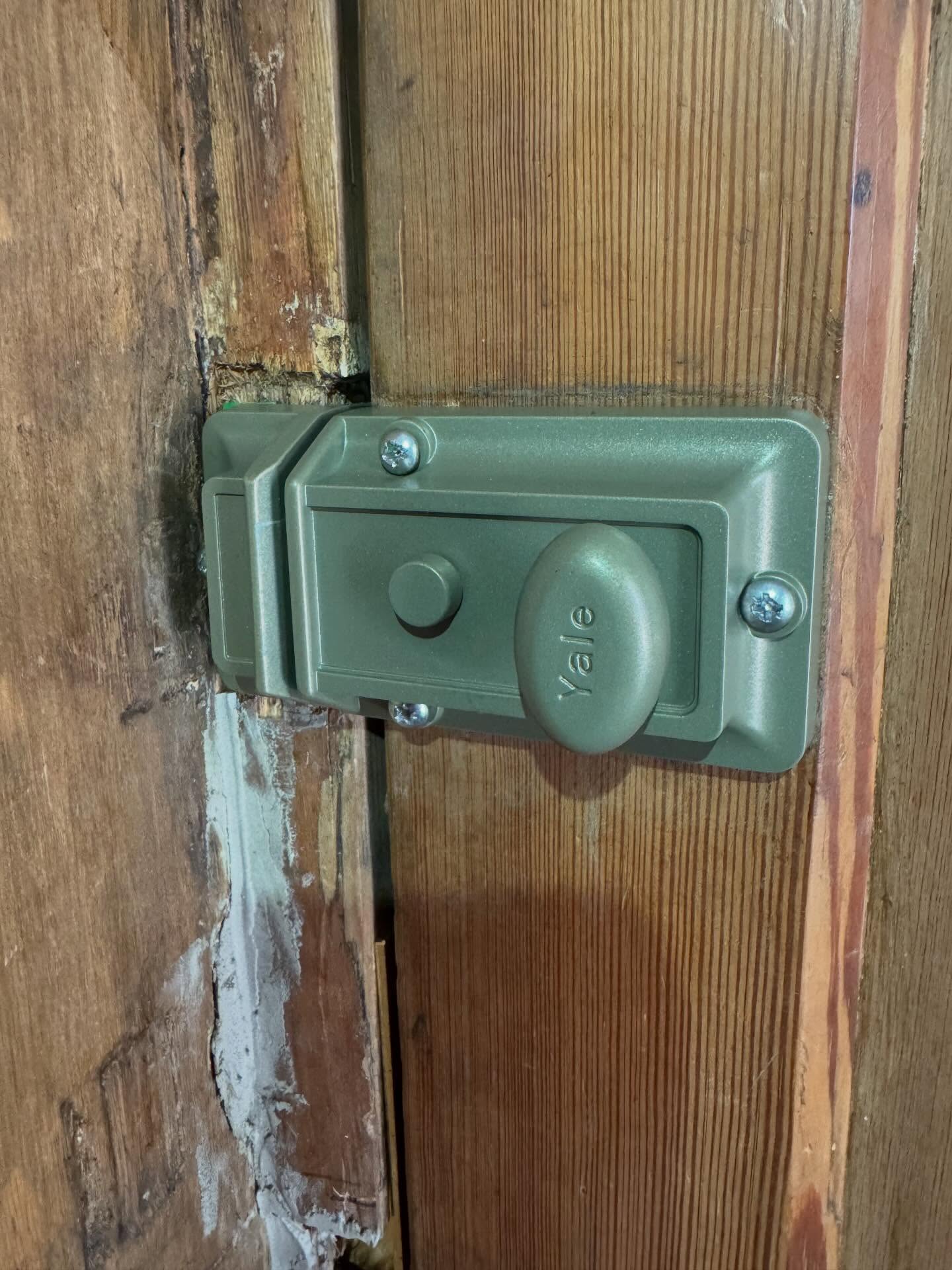 Yale 77 traditional night latch in green colour fitted to wooden door
