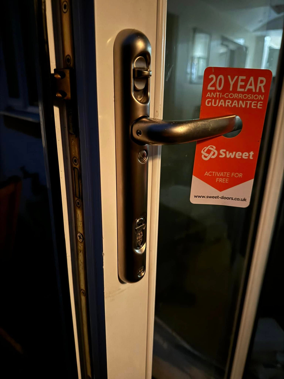 Yale anti snap lock fitted to Brisant Lock Lock high security door handle showing orange card with the words 20 year corrosion guarantee
